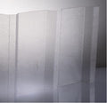 A translucent textured polycarbonate sheet with a frosted, pebbled surface, shown standing upright against a neutral gray background.