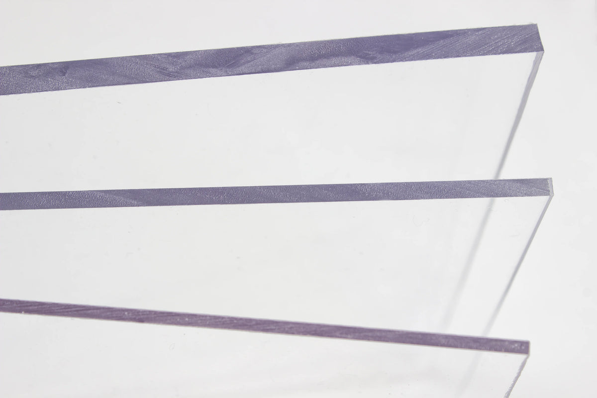 Three parallel clear acrylic strips with a light purple tint, arranged diagonally on a plain white background.