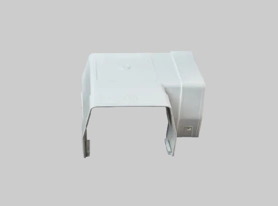 A white plastic electrical junction box cover or terminal block housing, shown from a three-quarters perspective against a solid orange background.