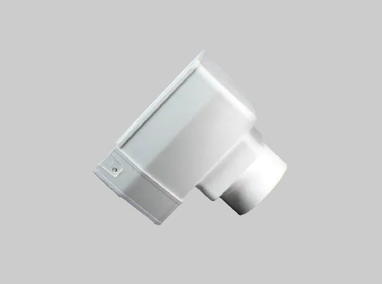 A white plastic elbow pipe connector shown at an angle against a solid orange background.