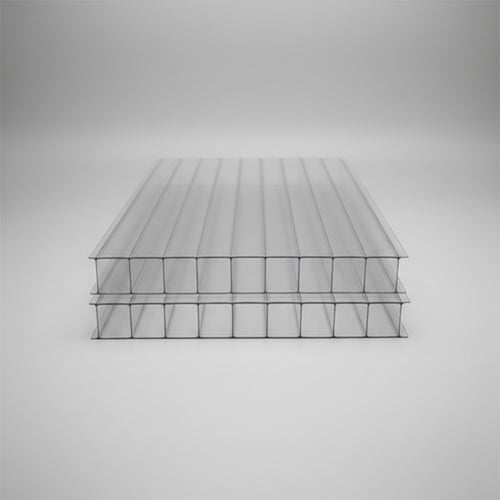 10mm Clear ribbed polycarbonate solar panel sheets stacked on a blue surface, showing their transparent structure and corrugated design.